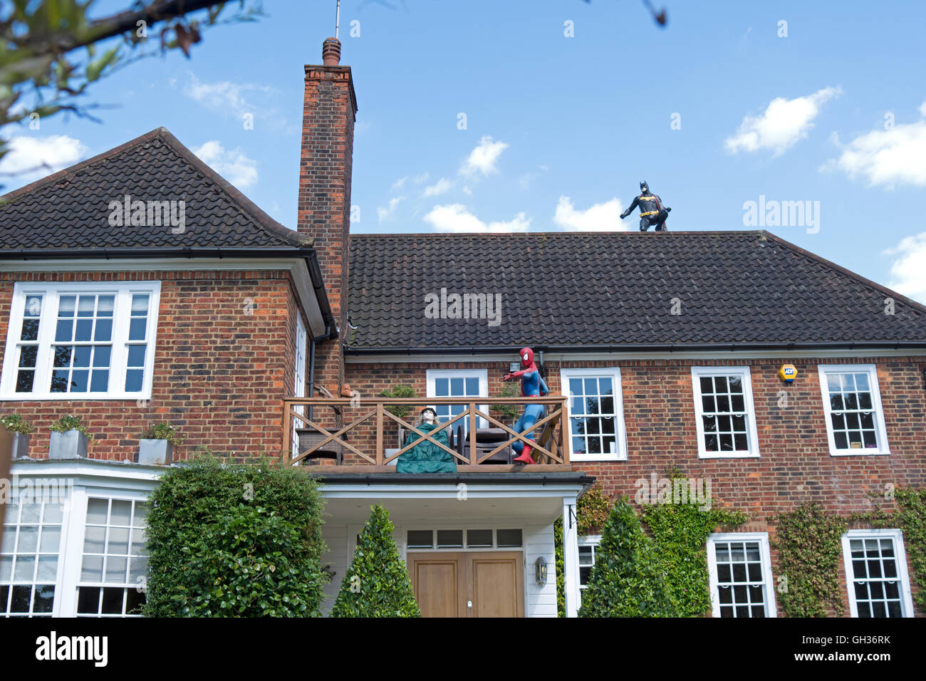 Life-size models of Batman and Spider-Man adorn a house in Hampstead Stock Photo