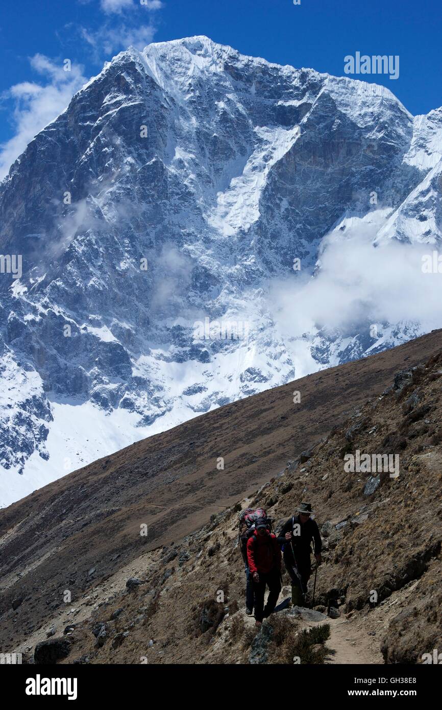 Guide and trekker in front of Taboche,  Chola Khola valley, Sagarmatha National Park, Solukhumbu District, Nepal, Asia Stock Photo