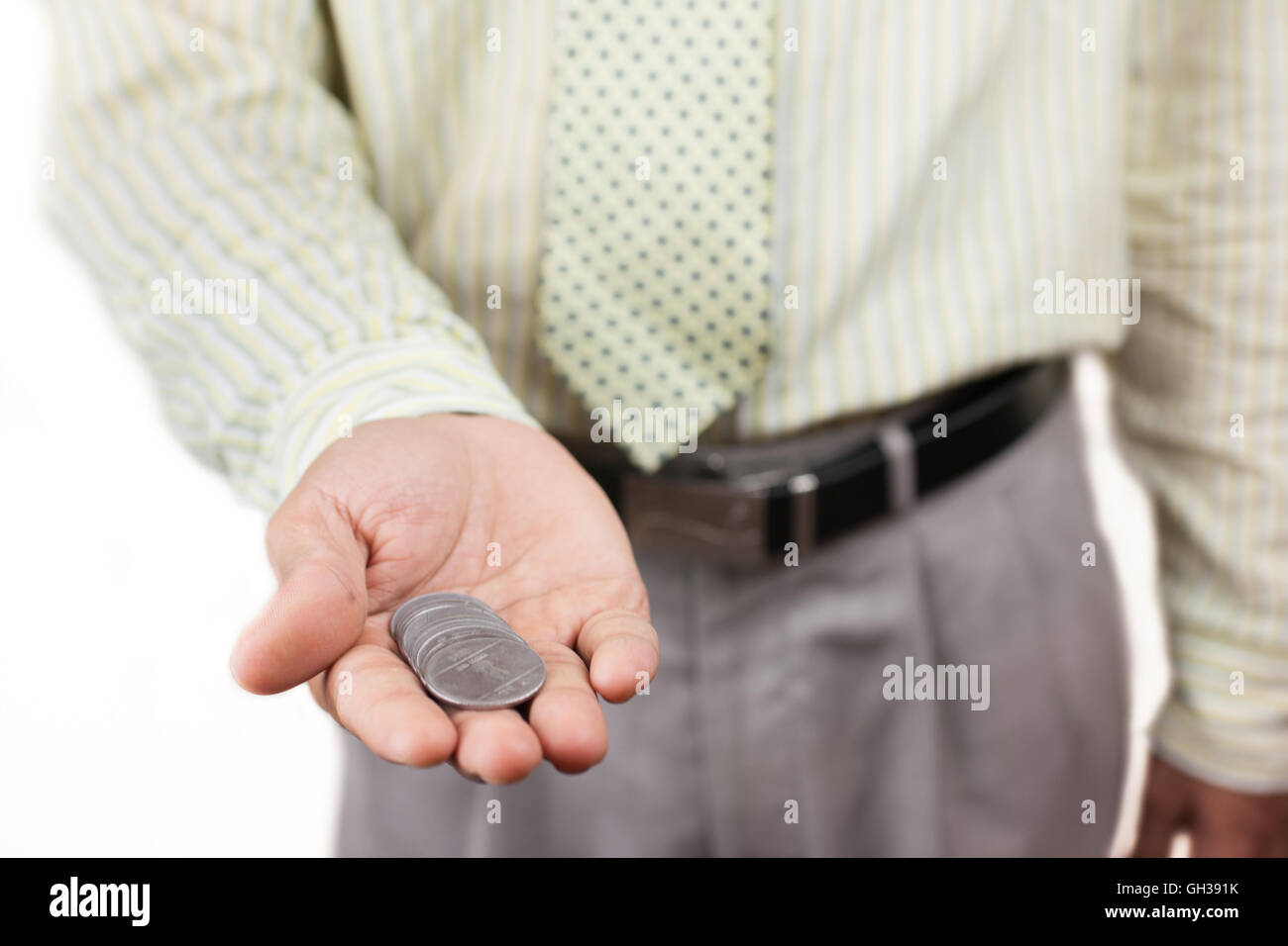 A business man holding a handful of loose change Stock Photo - Alamy
