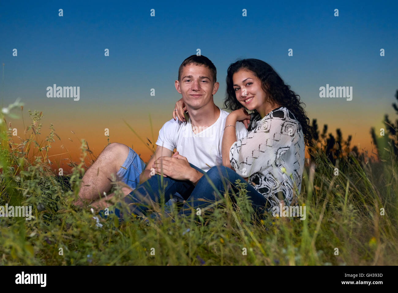 Couple embrace on hill sunset hi-res stock photography and images - Alamy