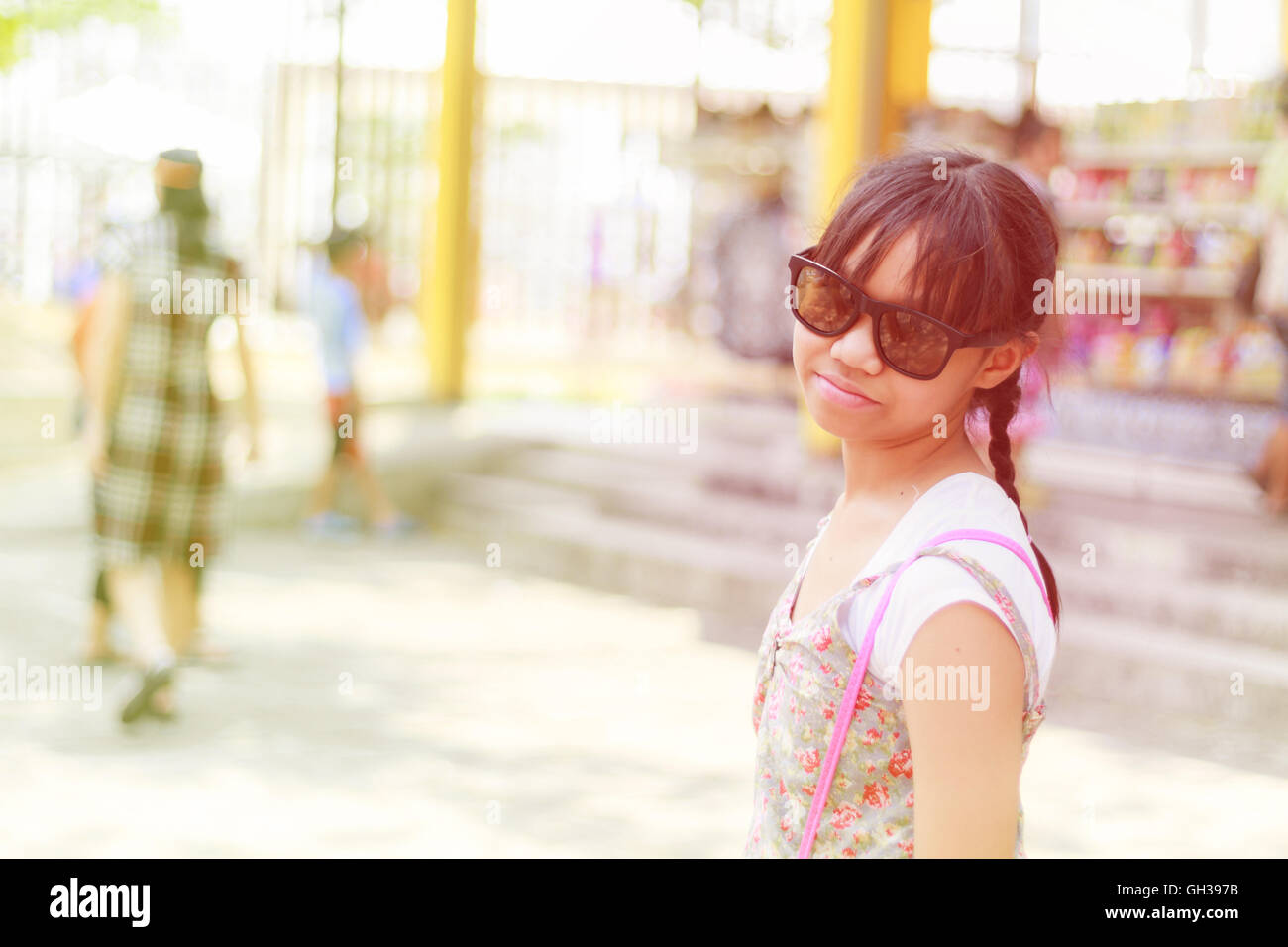 Asian child girl wearing a hat to the holiday. Sunlight effect. Stock Photo