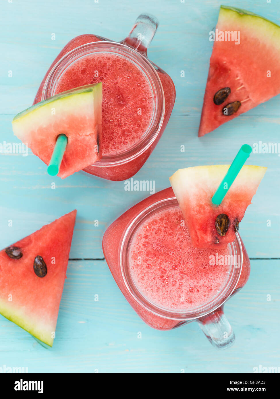 Watermelon smothie and slices on blue background Stock Photo - Alamy