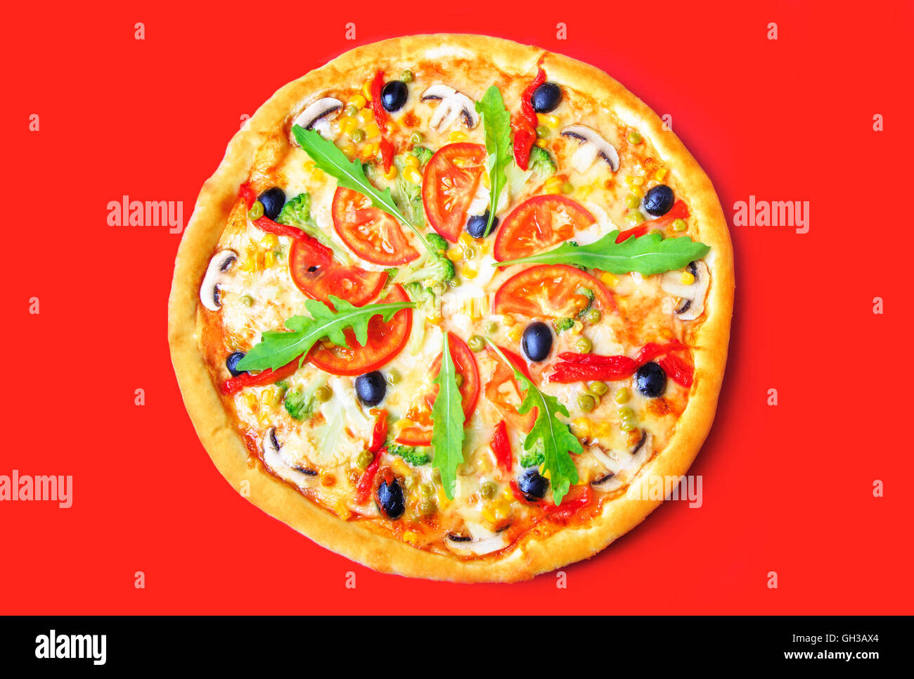 Delicious pizza with vegetables close-up on a red background Stock Photo