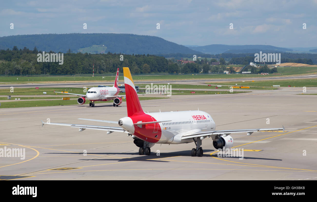 ZURICH - July 30:  Planes preparing for take off at Terminal A of Zurich Airport on July 30, 2016 in Zurich, Switzerland. Zurich Stock Photo