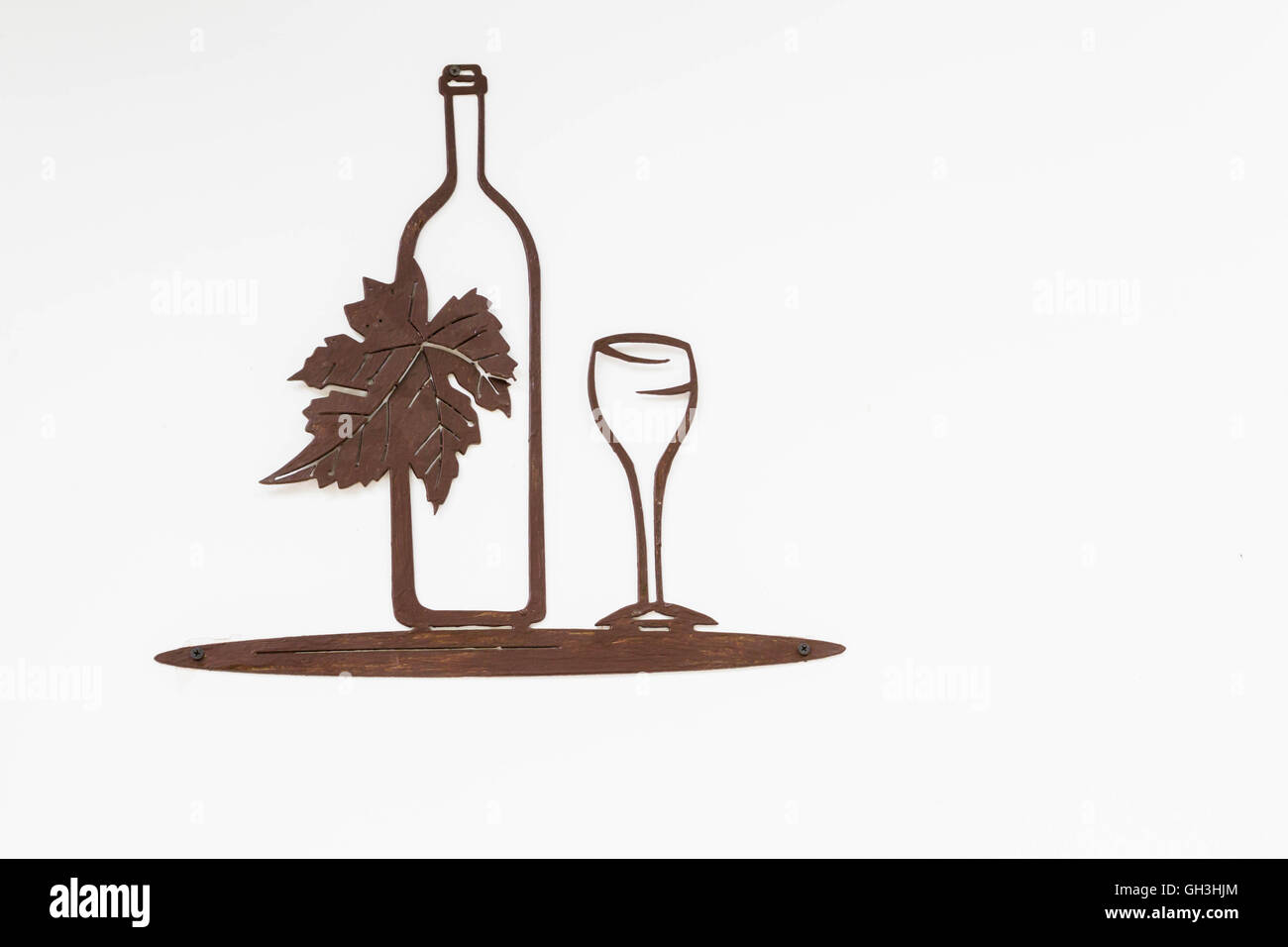 The picture on the wall of the bottle with a glass Stock Photo - Alamy