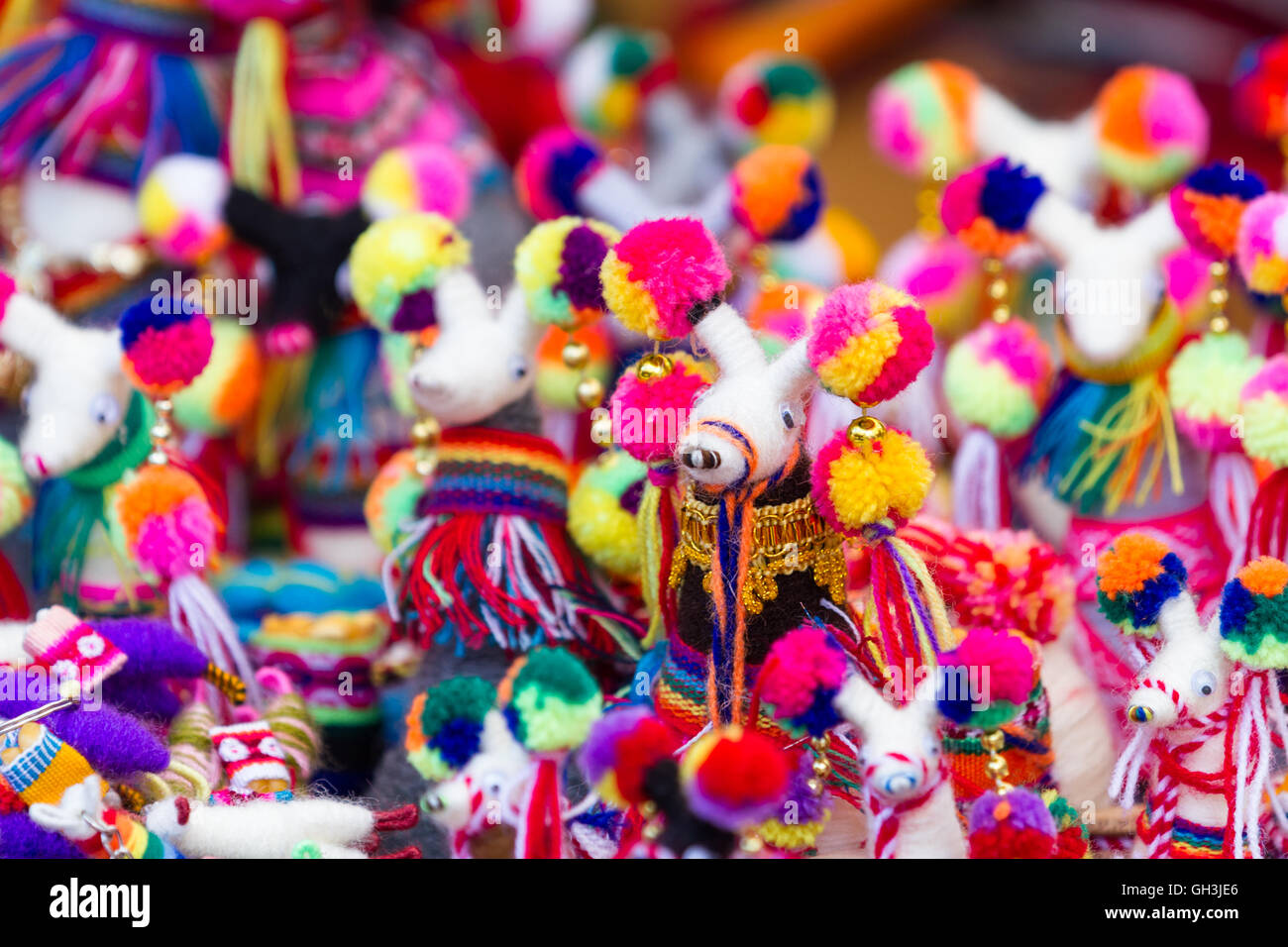 close up of a group pf dolls in a variety of classic Peruvian colors for sale in the Market at Pisac Stock Photo