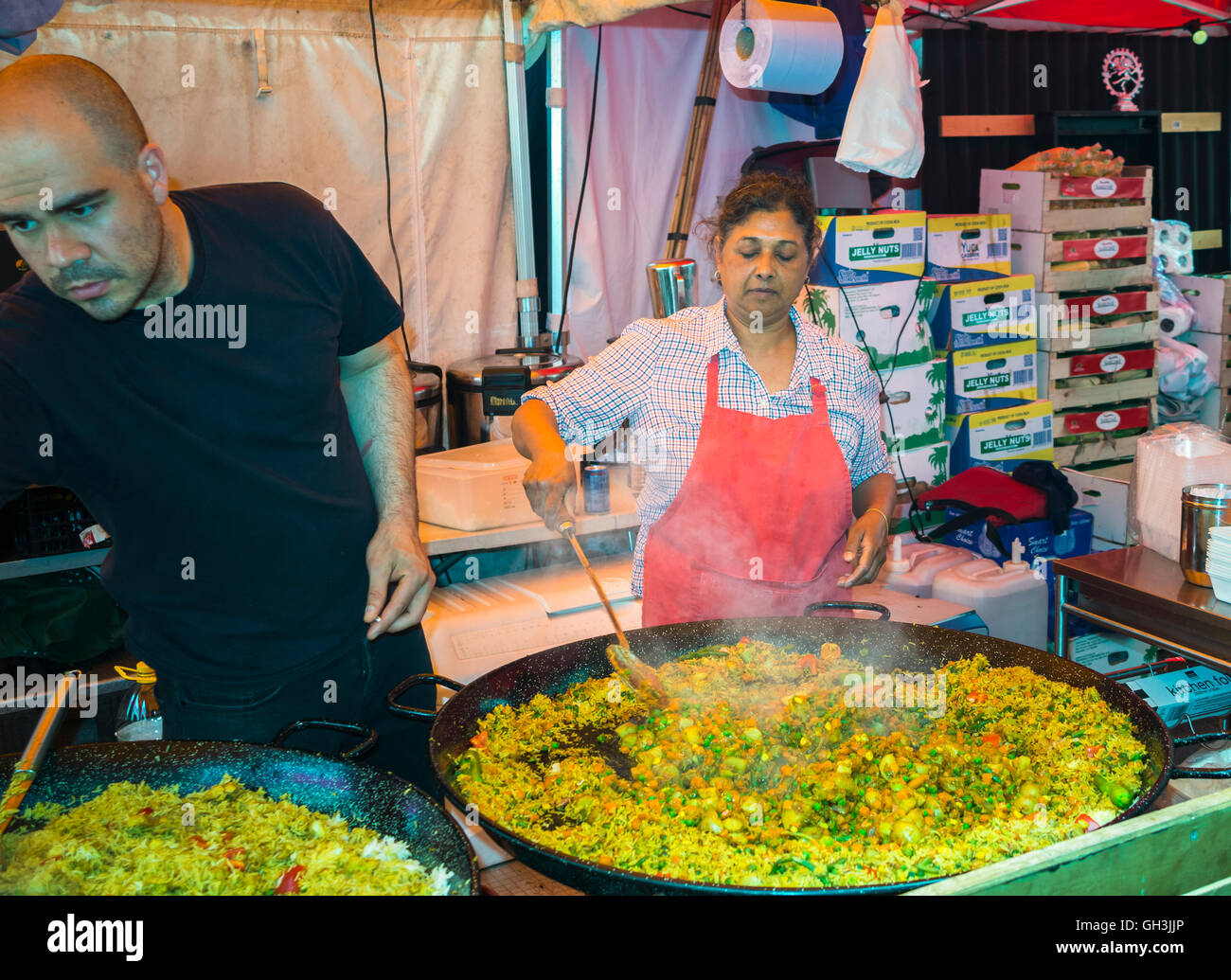 Large trays of stir fry risotto being cooked in a stall at the ...