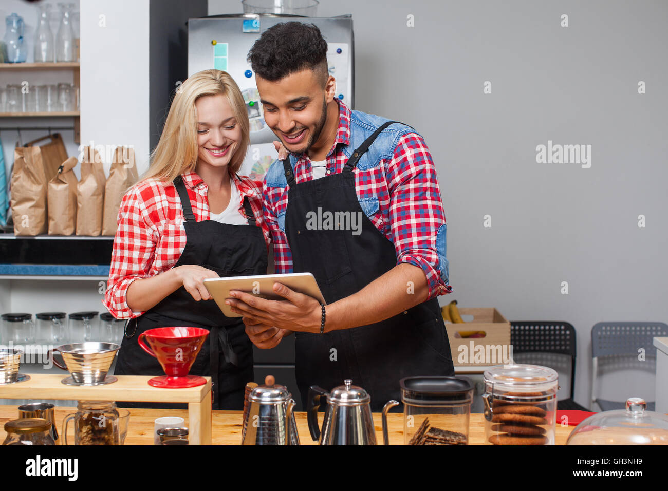 Barista coffee shop couple using tablet computer happy smile Stock Photo