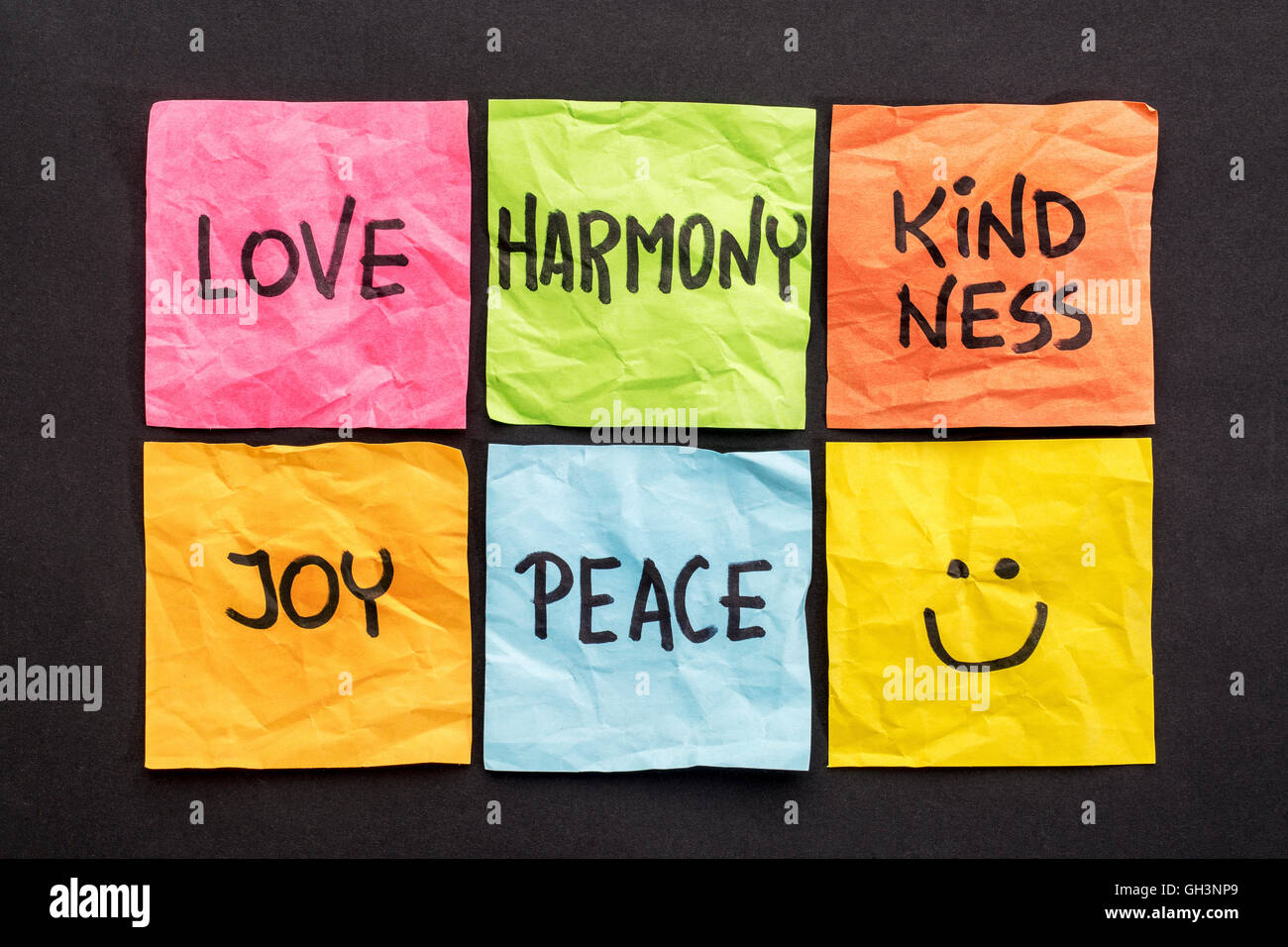 love, harmony kindness, joy and peace -  set of sticky notes with inspirational words and smiley Stock Photo