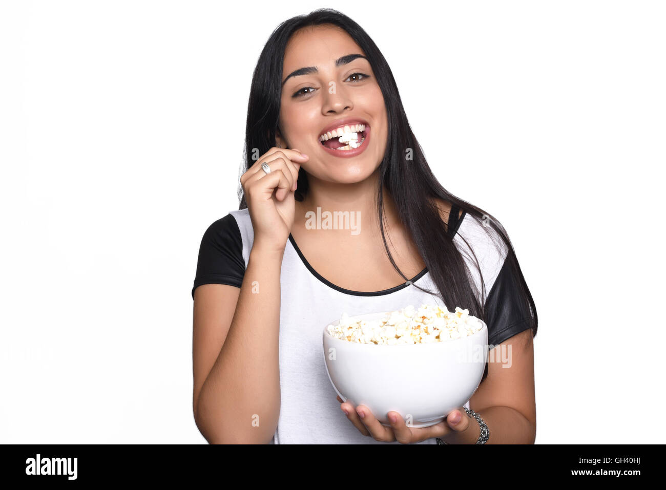 Young beautiful woman eating popcorn. Isolated white background Stock