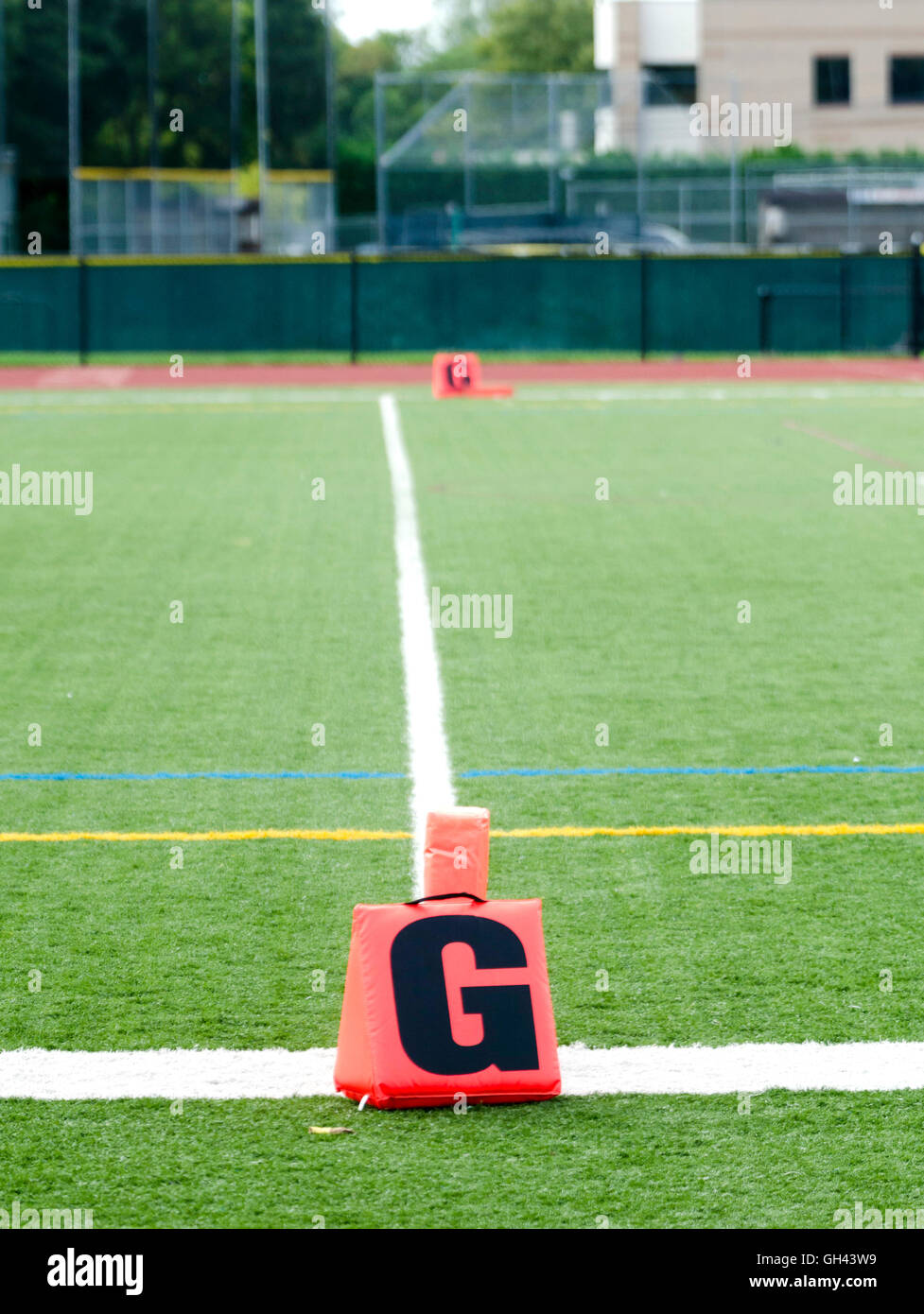 Orange goal marker on American football field Stock Photo