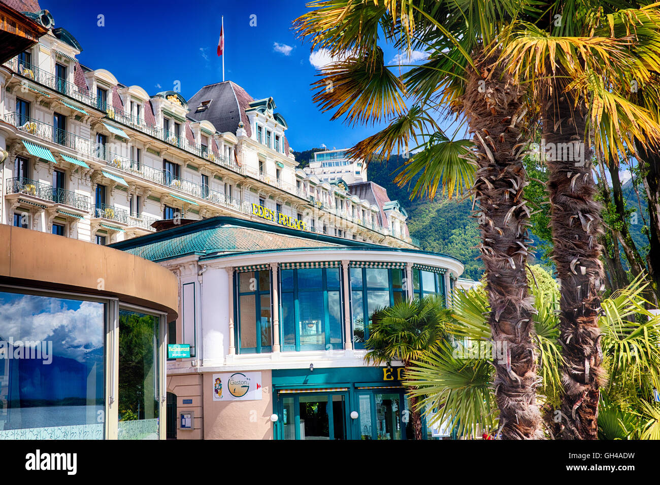Low Angle View of a Classic Hotel with Palm Trees, Eden Palace, Montreux, Vaud Canton, Switzerland Stock Photo