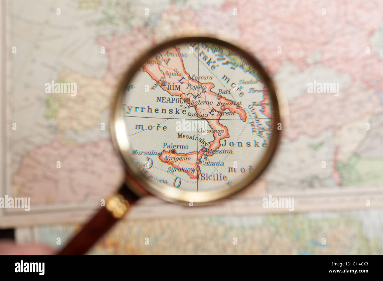 Magnifying Glass in front of a Italy map Stock Photo Alamy