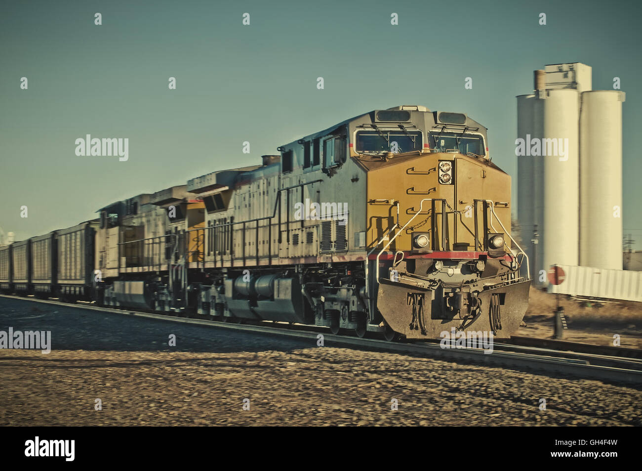 Freight train going through a rural Colorado town. Retro instagram look