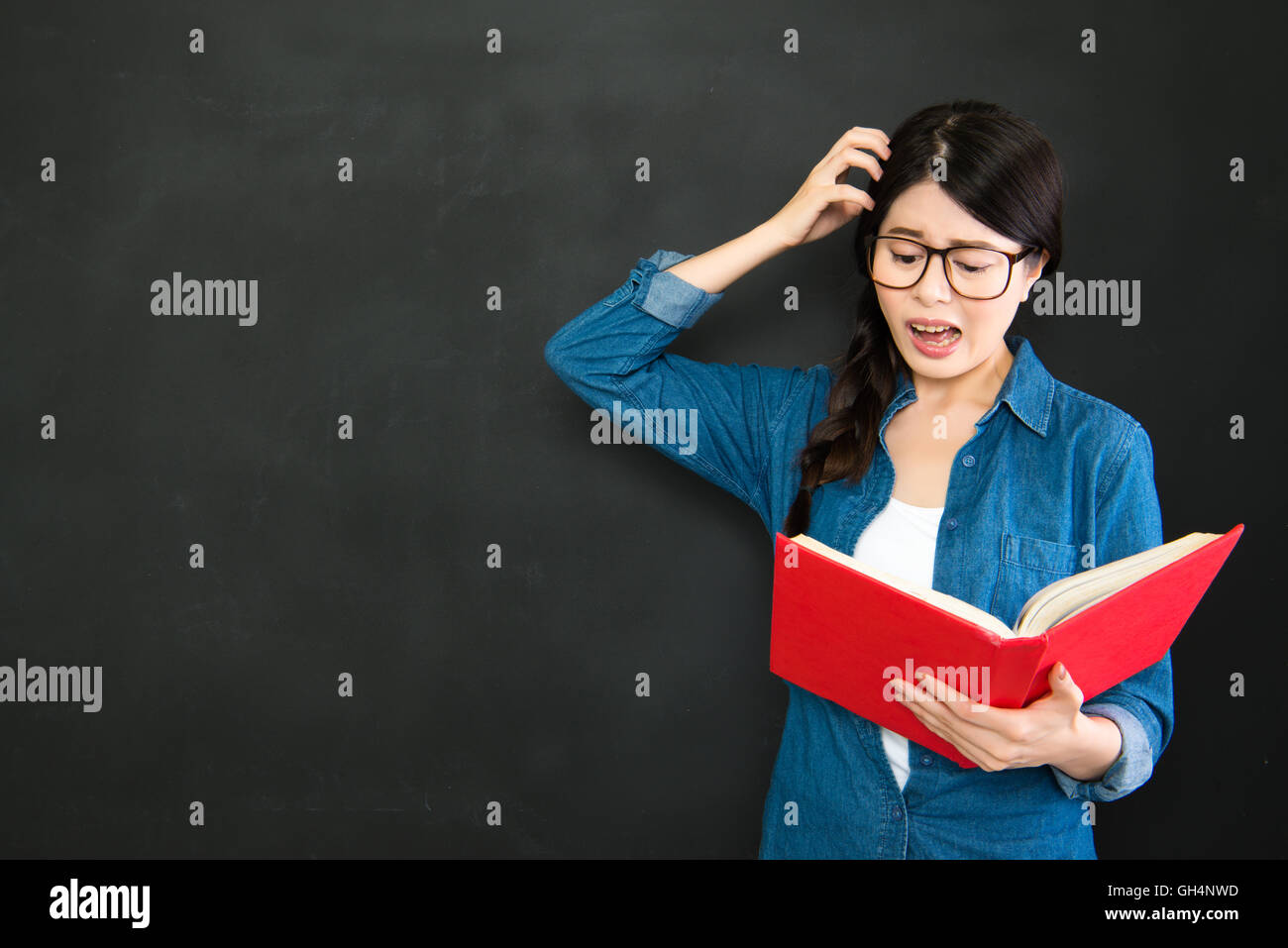 she is shocked she made a mistake for her assignment in school Stock Photo