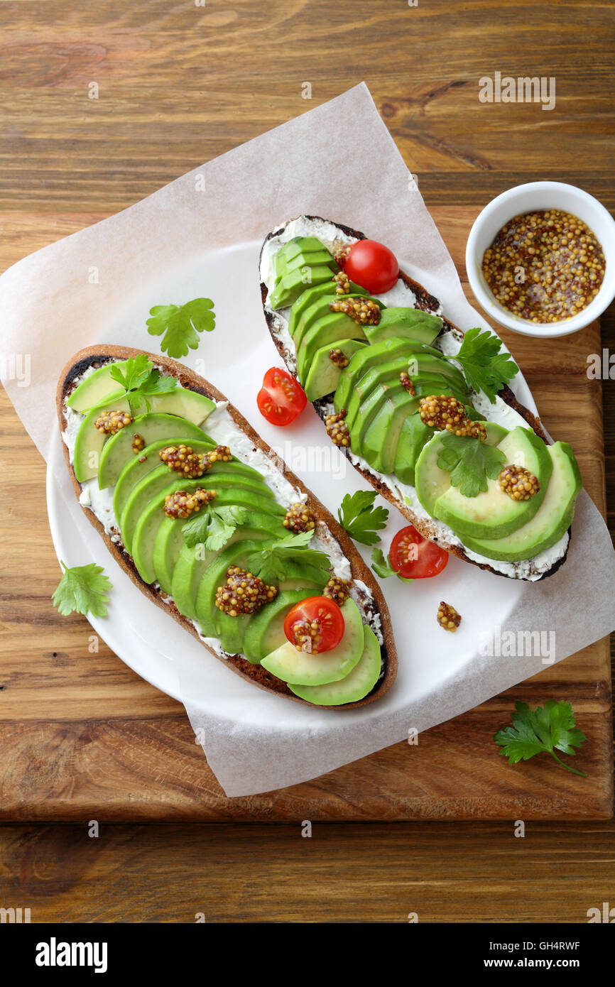 Fresh avocado toasts for breakfast. Healthy eating Stock Photo