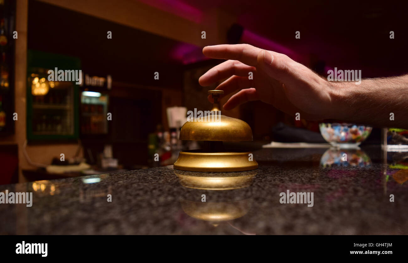 man hand ring the bell at the hotel front desk Stock Photo - Alamy