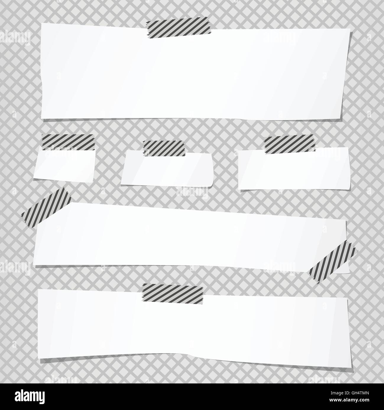 Pieces of cut white note paper are stuck with striped sticky tape on ...