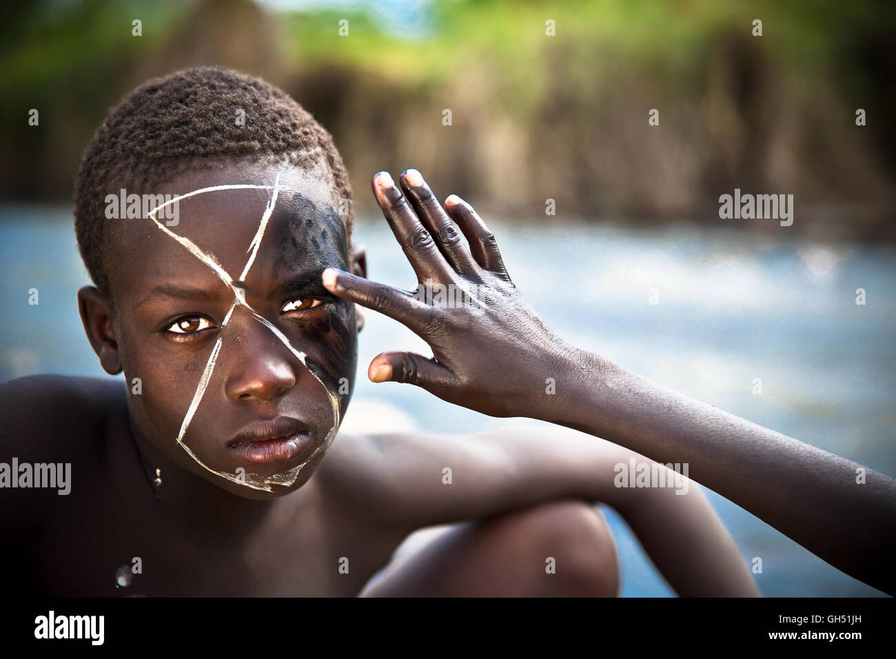 Young boy from Suri tribe with traditional bodypainting. Stock Photo