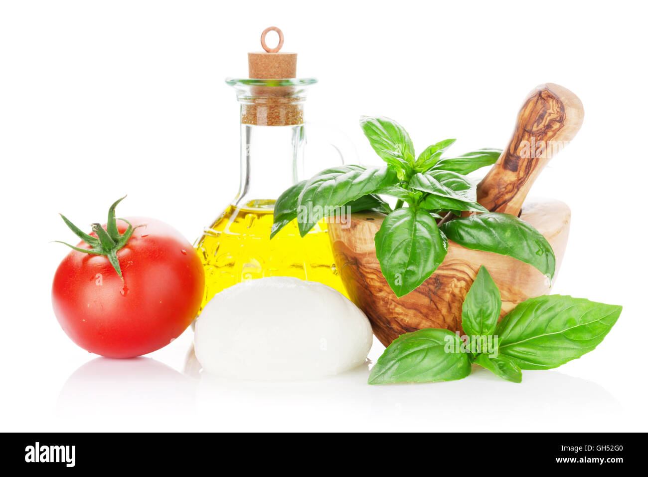 Mozzarella cheese, olive oil, tomato and basil herb leaves. Isolated on ...