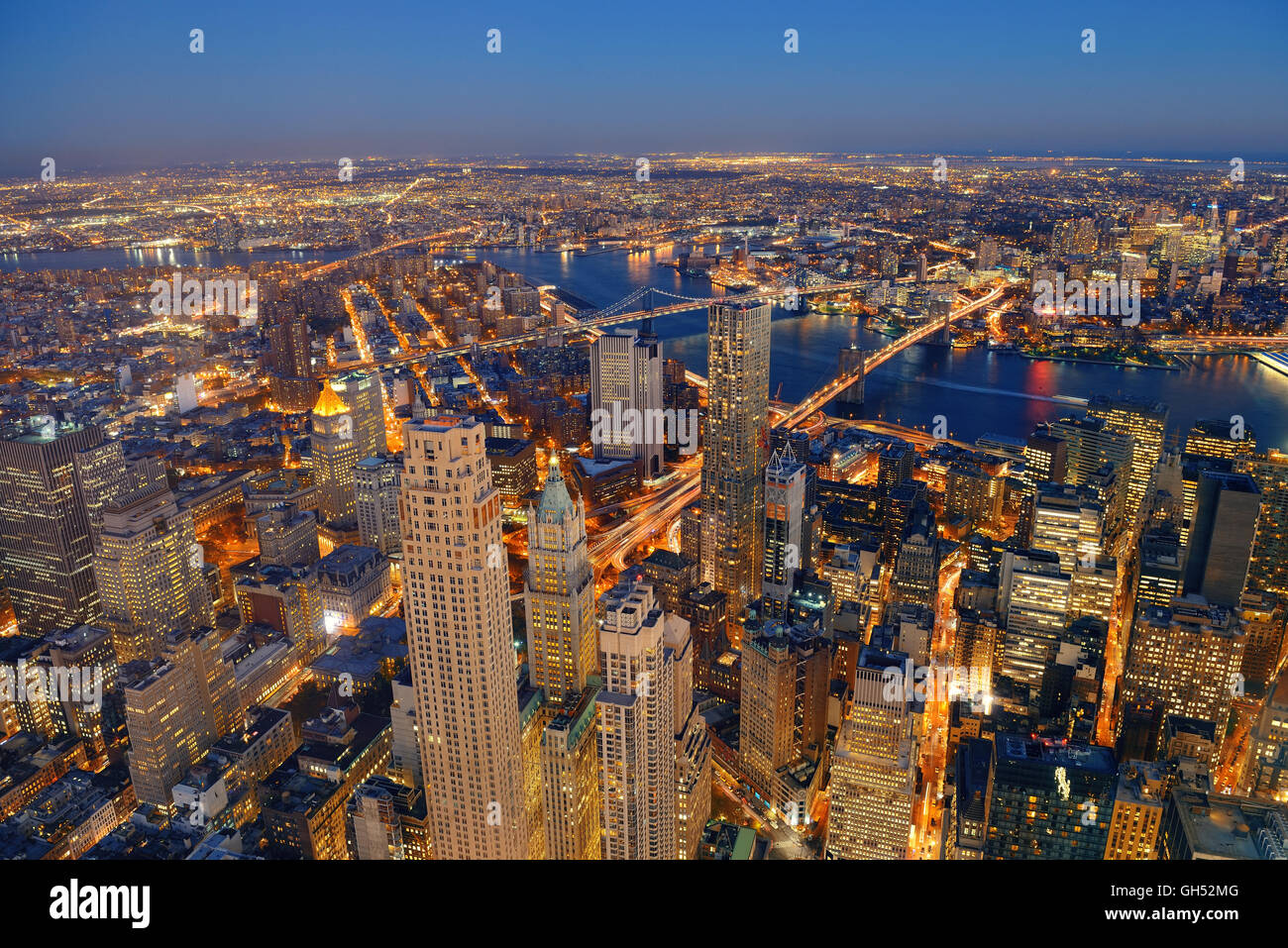 Rooftop at dusk view of New York City downtown with urban skyscrapers ...