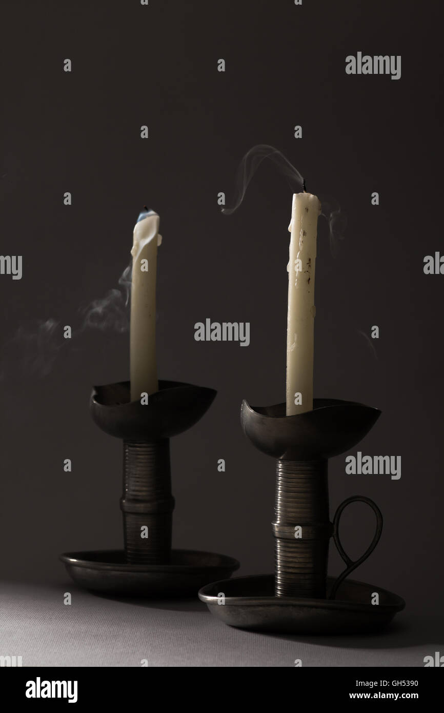 Two Blown Out Smoking Candles on Iron Candlesticks Stock Photo Alamy