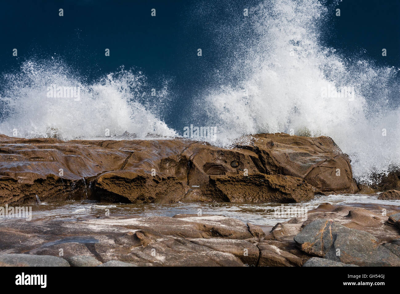 View of a crashing wave on the rocks Stock Photo