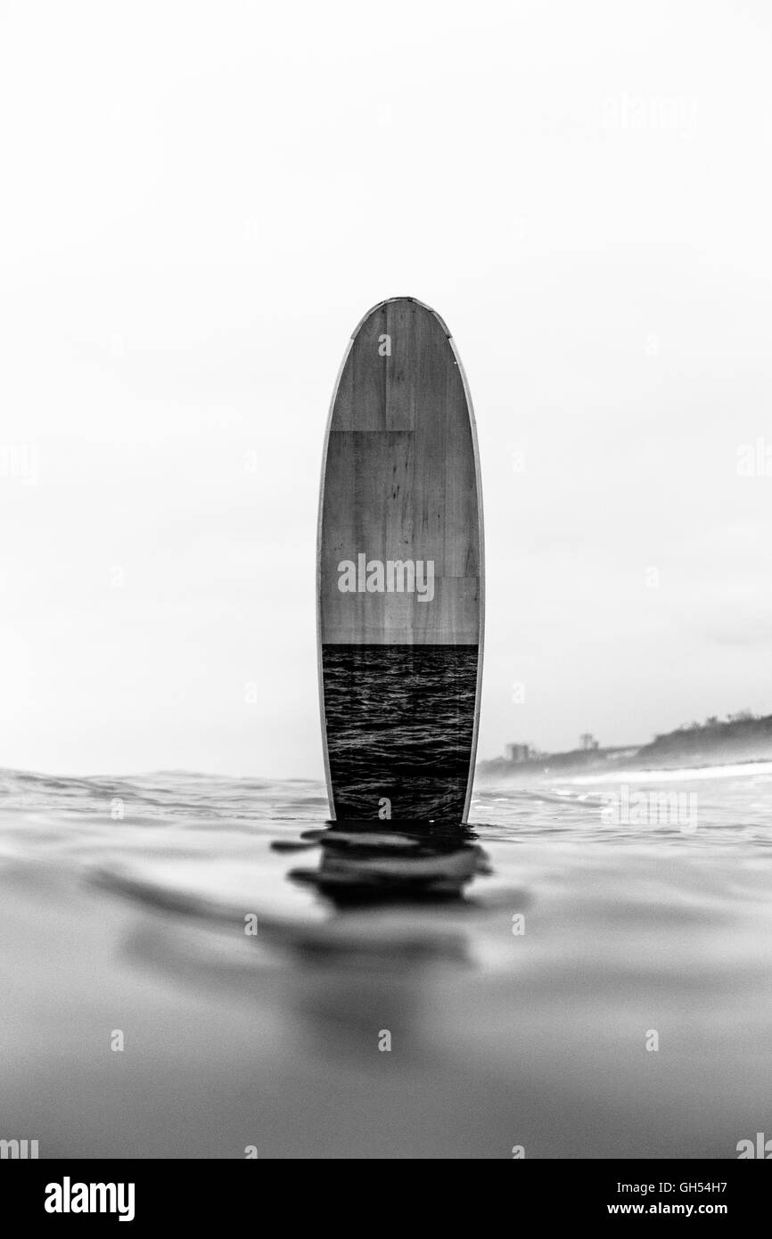 Surfboard standing in the middle of the ocean Stock Photo