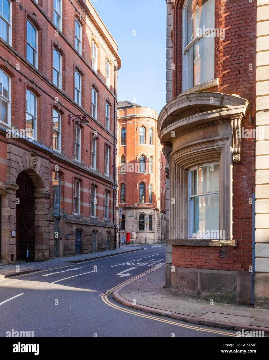 A narrow street and tall buildings. Former Victorian factories and warehouses, typical of the Lace Market area in Nottingham, England, UK Stock Photo