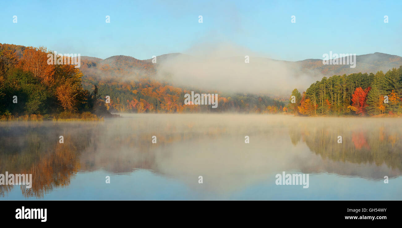 Lake fog panorama with Autumn foliage and mountains with reflection in ...