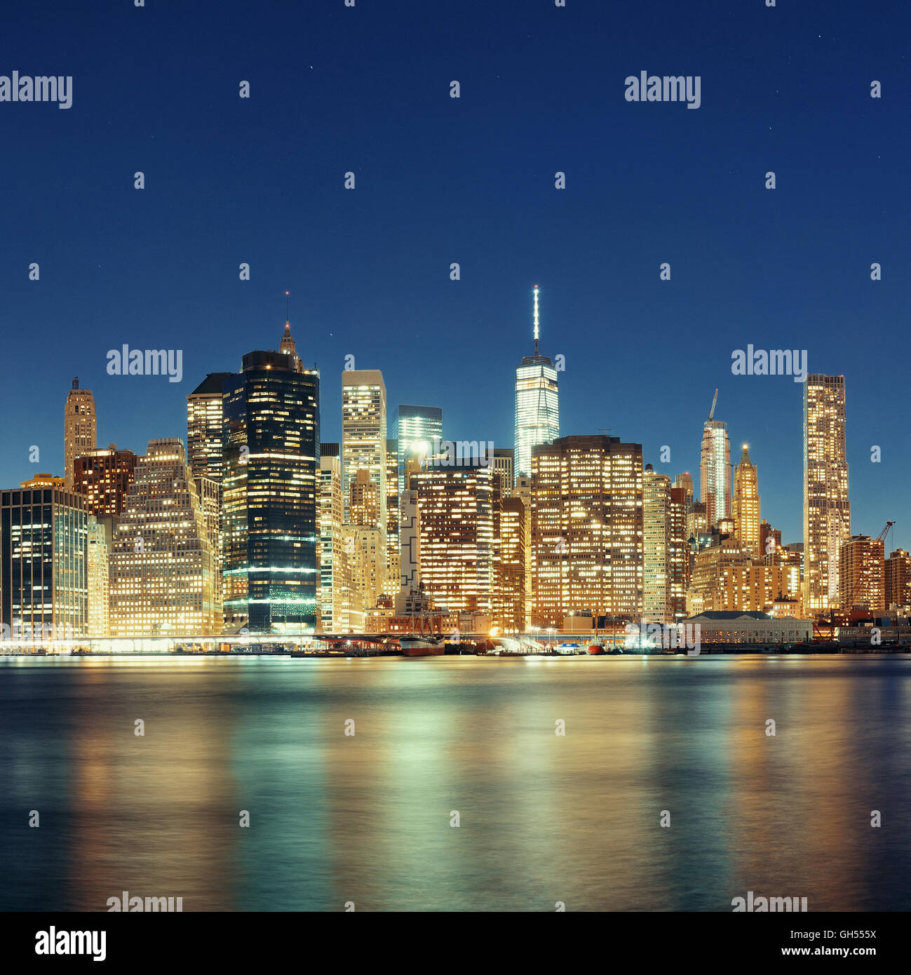 Downtown Manhattan skyline over East River at night in New York City ...