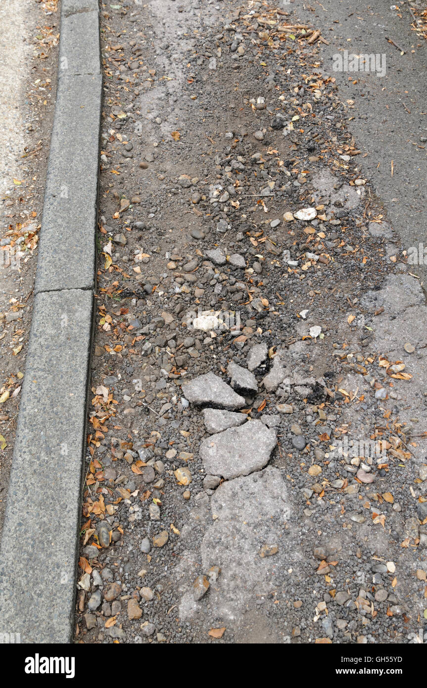 Cracked and damaged asphalt pavement Stock Photo