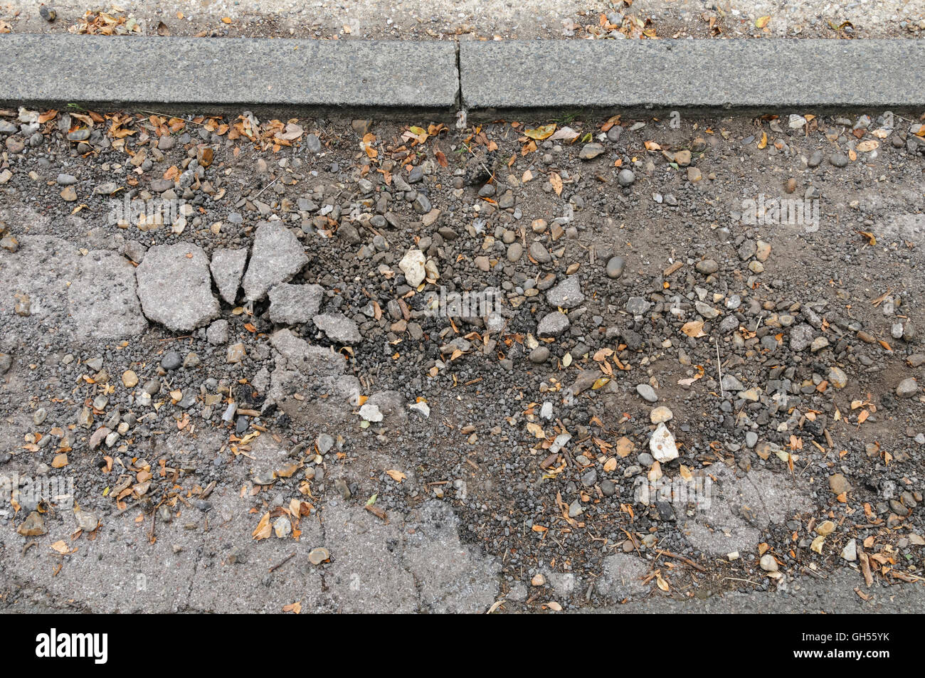 Cracked and damaged asphalt pavement Stock Photo