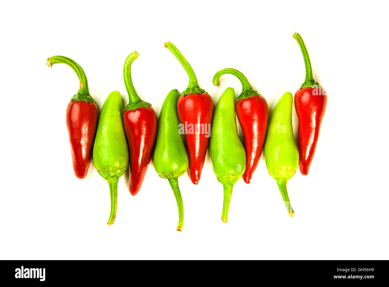 Many ripe red and green Chilli peppers on over white Stock Photo