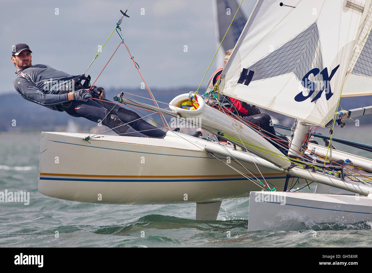 Competitive sailing dinghy racing, in the estuary of the River Exe
