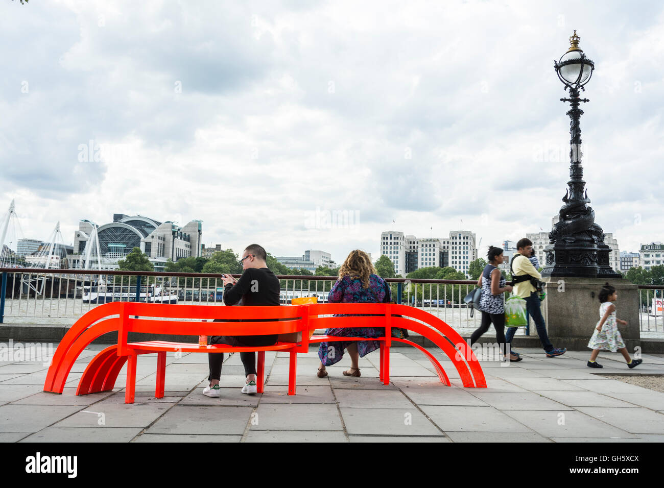 A couple sitting on one of by Jeppe Hein's Modified Social Benches on London's South Bank, SE1, UK Stock Photo