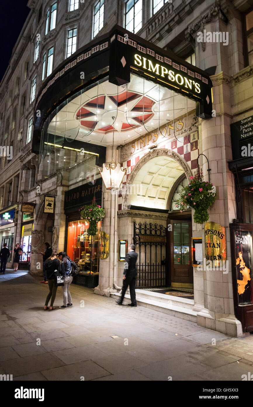 London, England, UK: A night time view of the entrance to Simpson's in the Strand. Stock Photo