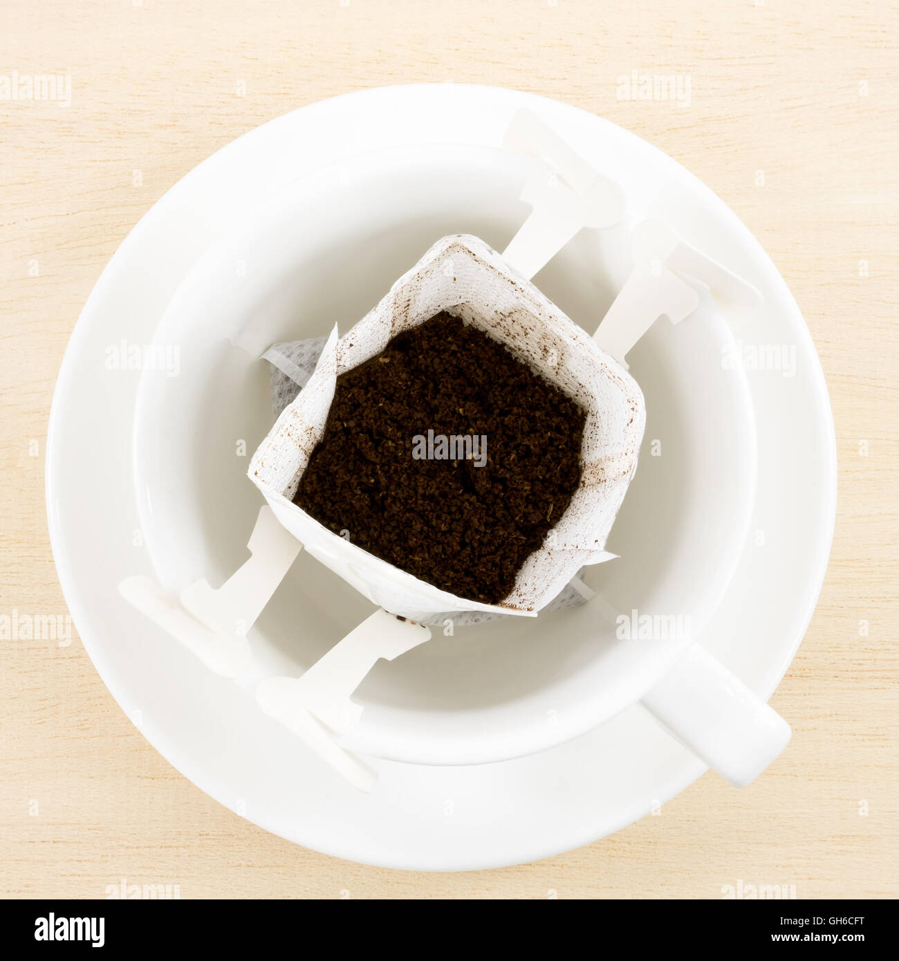 The instant freshly brewed coffee drip bag on white coffee cup Stock