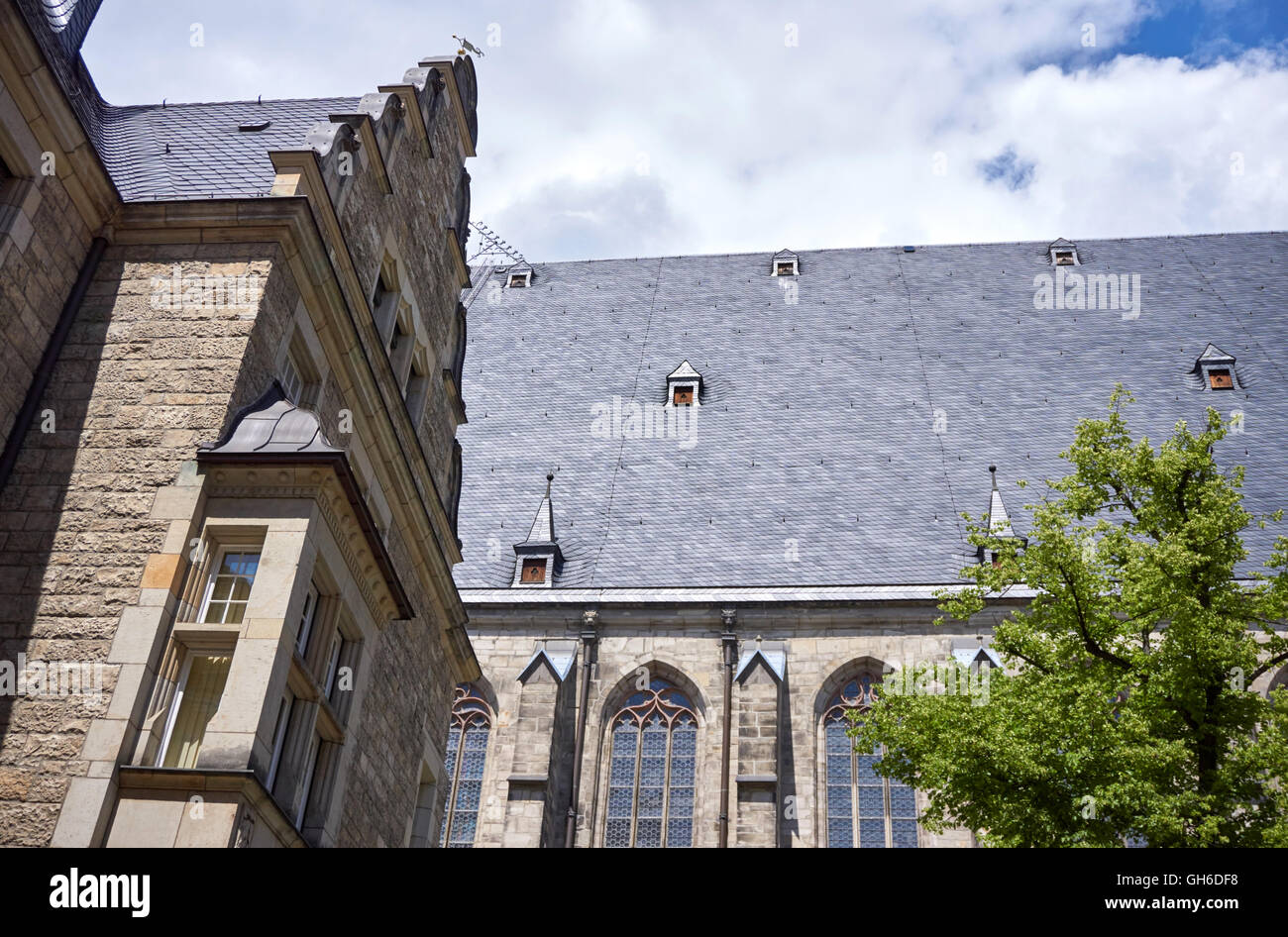Roof section and windows of the Thomaskirche with part of the adjoining Thomasschule, Leipzig, Germany Stock Photo