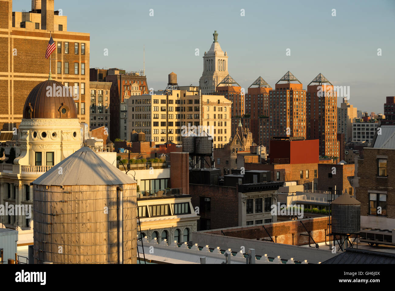 Sunset view of rooftops of the Flatiron District with water towers and