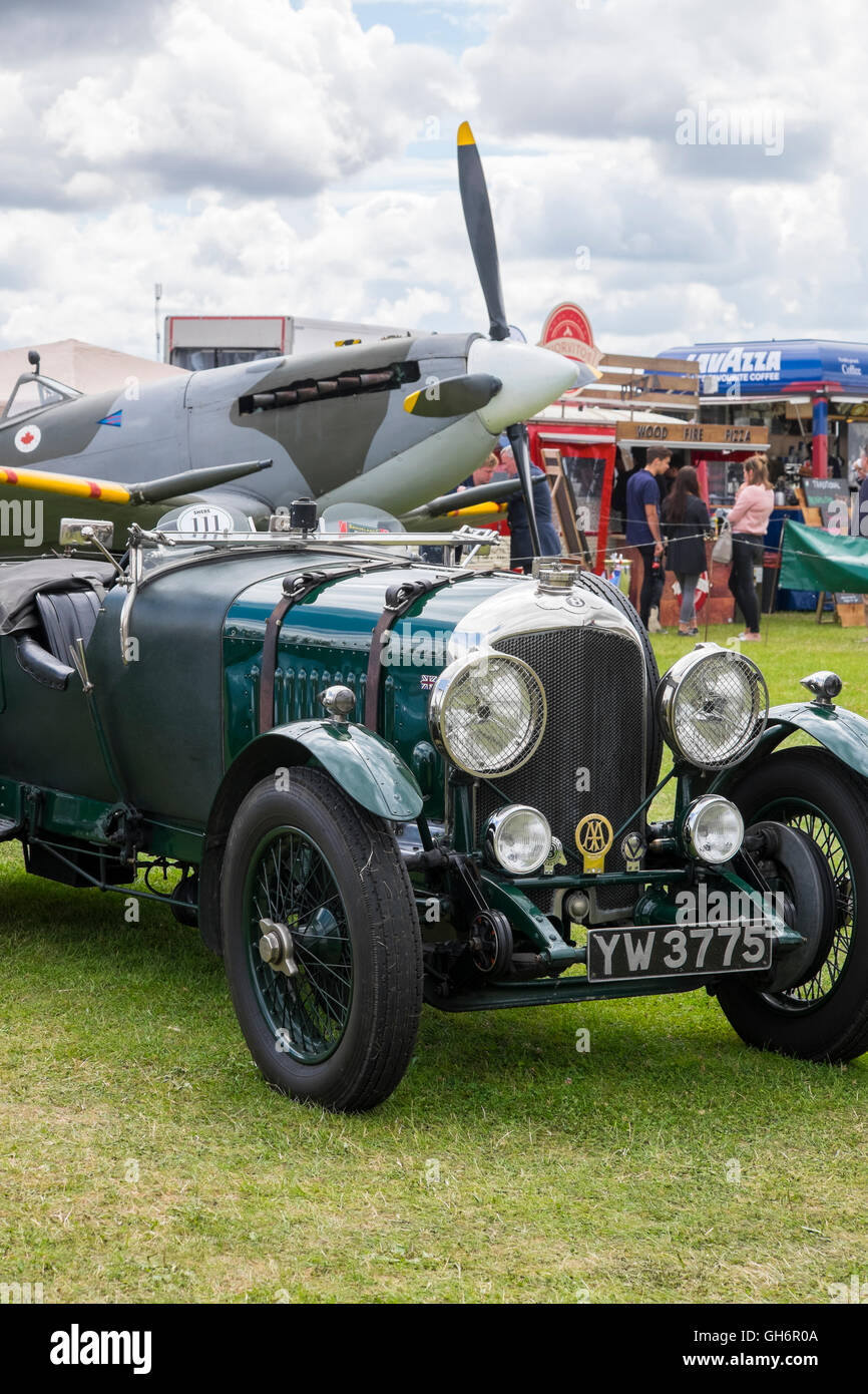 1928 4.5 litre Bentley and WW2 Spitfire at the 2016 Silverstone Classic event, UK Stock Photo