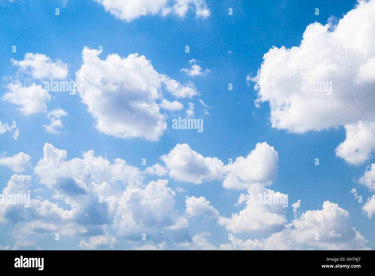 Cumulus clouds in bright blue sky at daytime, natural background photo Stock Photo