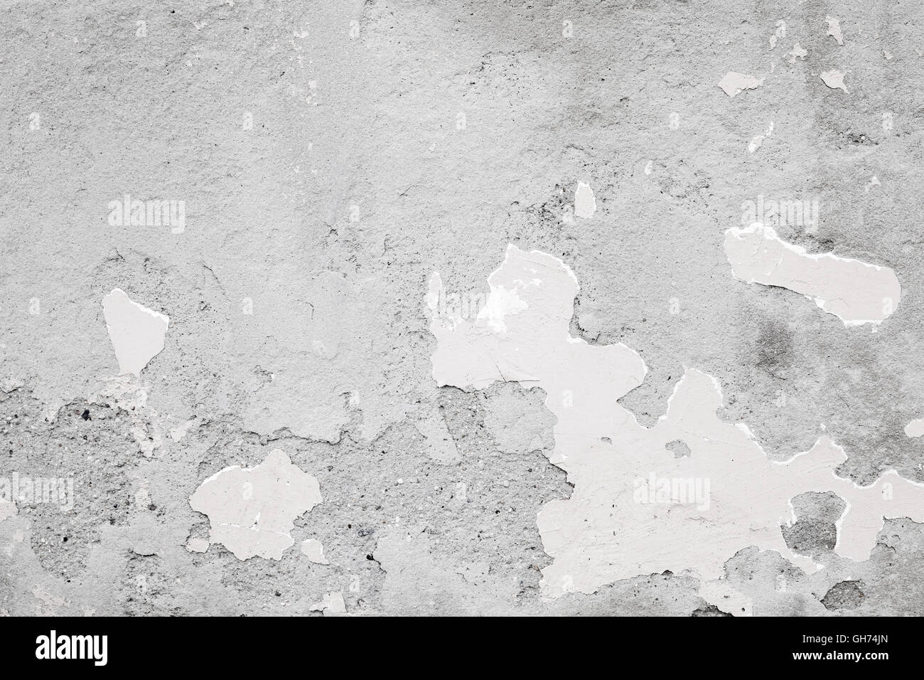 Concrete wall, background photo texture with damaged plaster and white paint layer Stock Photo
