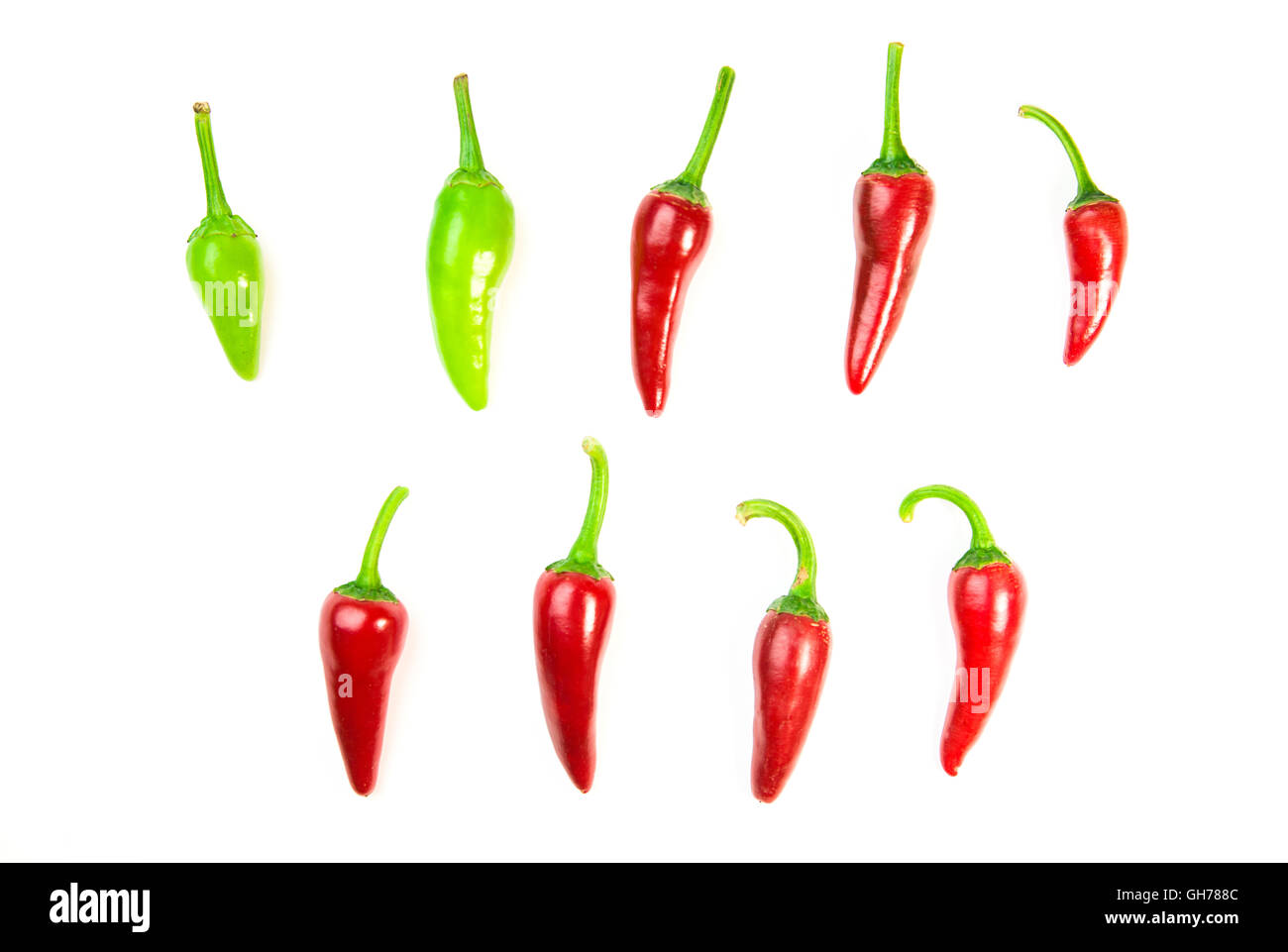 Many ripe red and green Chilli peppers on over white Stock Photo
