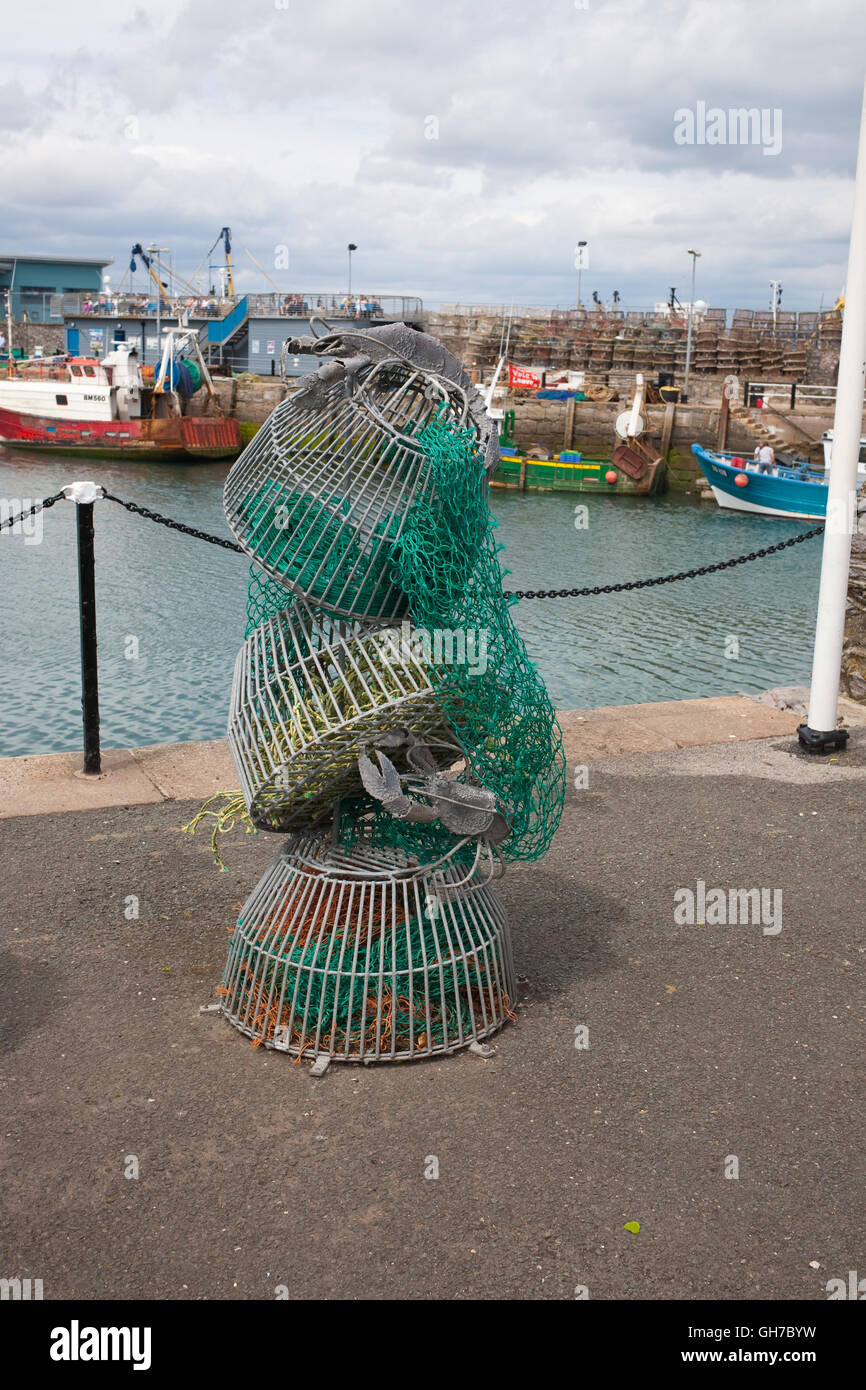 lobster or crab pots stacked on brixham harbourside Stock Photo