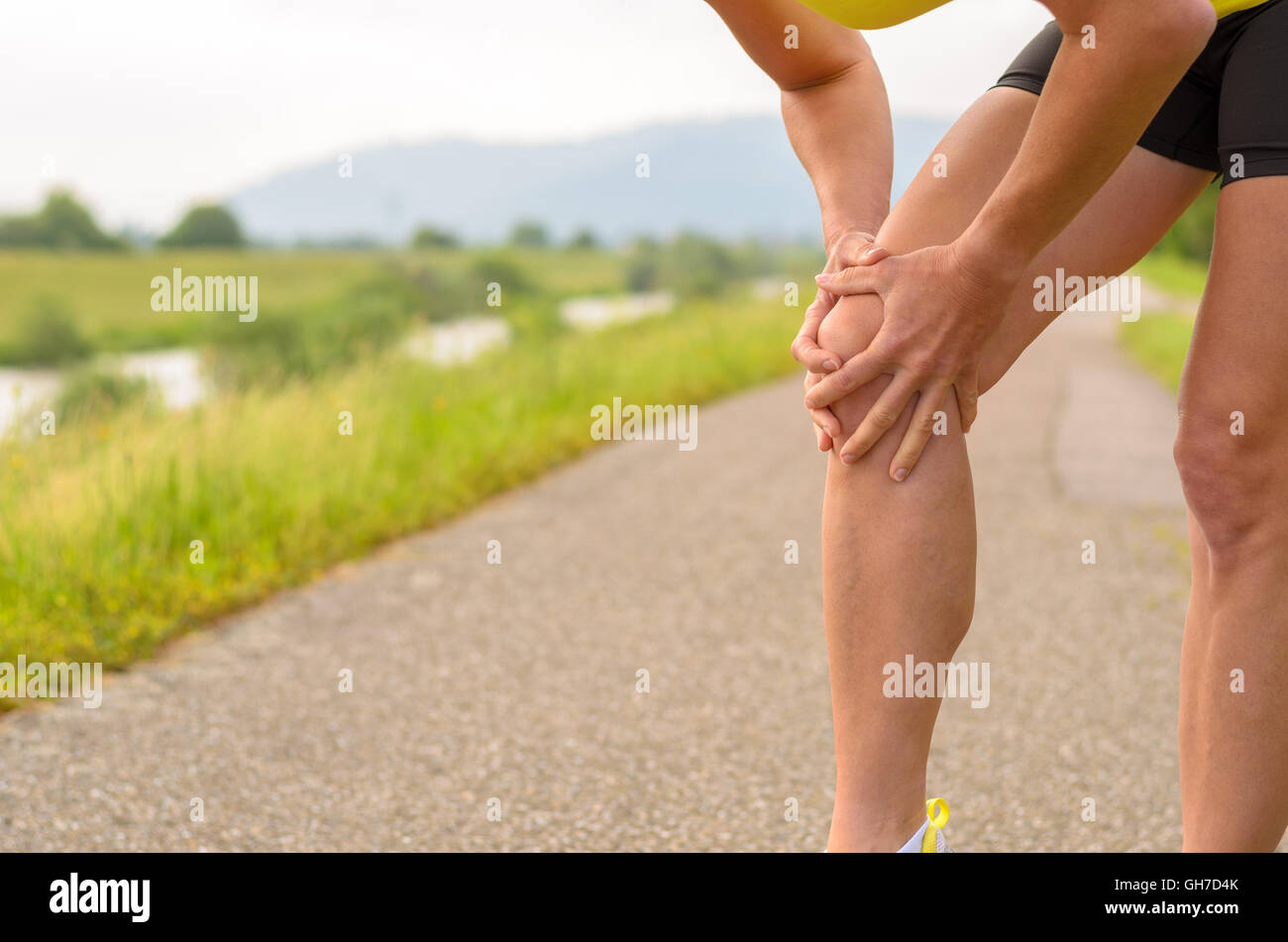 Close up Athletic Woman Holding her Painful Injured Knee While Doing an ...
