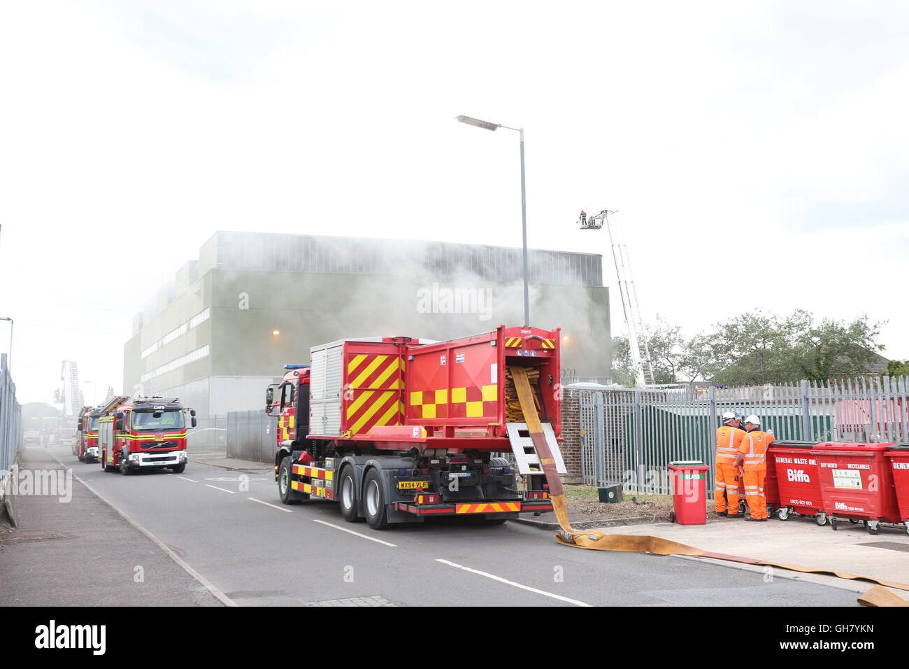 Marchwood, Hamphire, UK. 8th August 2016. Emergency crews from Hampshire fire and rescue service and South central  ambulance  service remain at the  cene of a  fire that broke out just after lunchtime today.  Fire crews have been brought from a far a field as Portsmouth to tackle the blaze at the fire at the recycling centre in East Road  Marchwood.  Eight fire engines two aerial ladders  and the incident command unit from Eastleigh been brought in to put out the fire out. Credit:  uknip/Alamy Live News Stock Photo