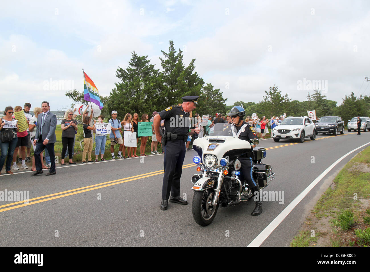 Osterville, Massachusetts, USA. 6th August, 2016. Police officers talk during a protest opposing Republican presidential nominee Donald Trump, near a fundraiser businessman William Koch is hosting for Trump. Credit:  Susan Pease/Alamy Live News Stock Photo