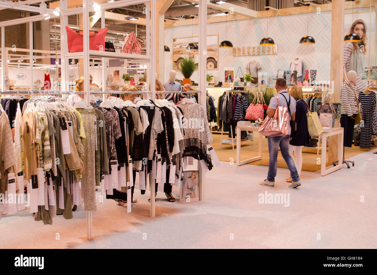 Fashion buyers browse the exhibition halls at Moda Spring Summer 2017, Birmingham NEC, UK. Moda, Britain's premier trade fashion exhibition, highlighted the Spring Summer 2017 ranges at Birmingham's NEC, 7th-9th August 2016. Featuring womenswear, lingerie, swimwear, footwear, accessories, and menswear, the exhibition reported good trade, with buyers visiting from across the UK. As well as the vast array of well over 1000 exhibitors showing their ranges to buyers, catwalk shows and business lectures ran throughout each day. Credit:  Antony Nettle/Alamy Live News Stock Photo