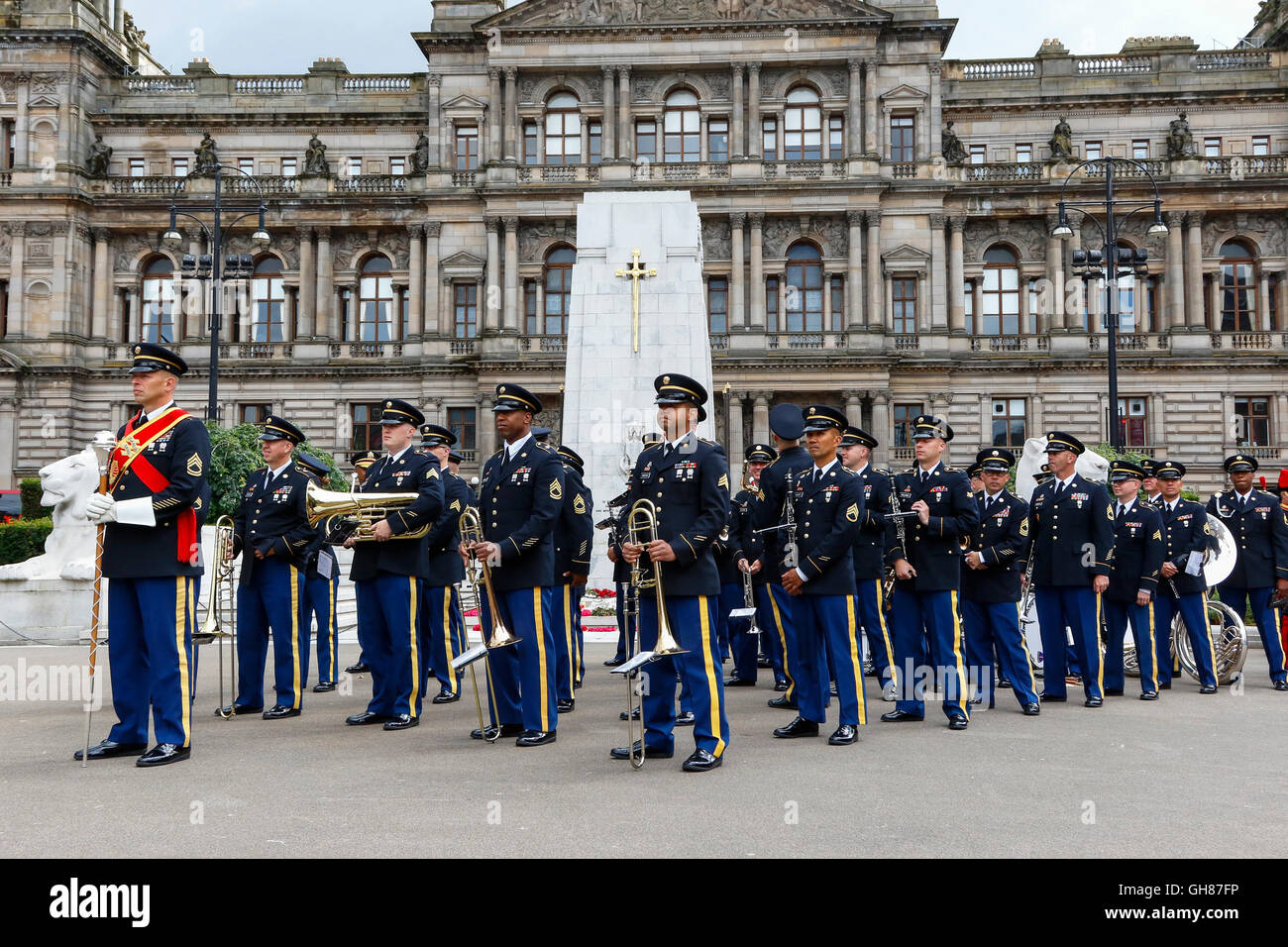 Glasgow, UK. 9th August, 2016. On the second day of 'Piping Life' the bands from The Royal Edinburgh Military Tattoo parade around George Square before entering the Piping Live arena for a spectacular display. The image is of USA Army Band and Chorus marching in George Square in front of the Cenotaph and City Chambers. Credit:  Findlay/Alamy Live News Stock Photo